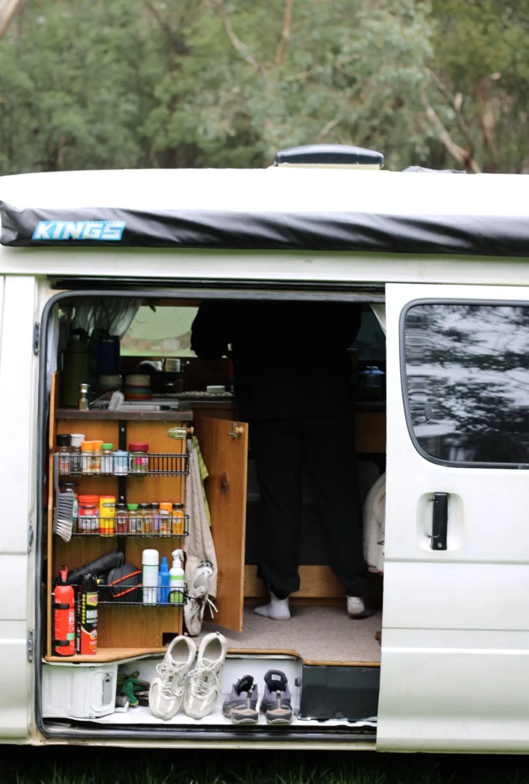 Side door open showing the pantry shelves, spice rack and storage