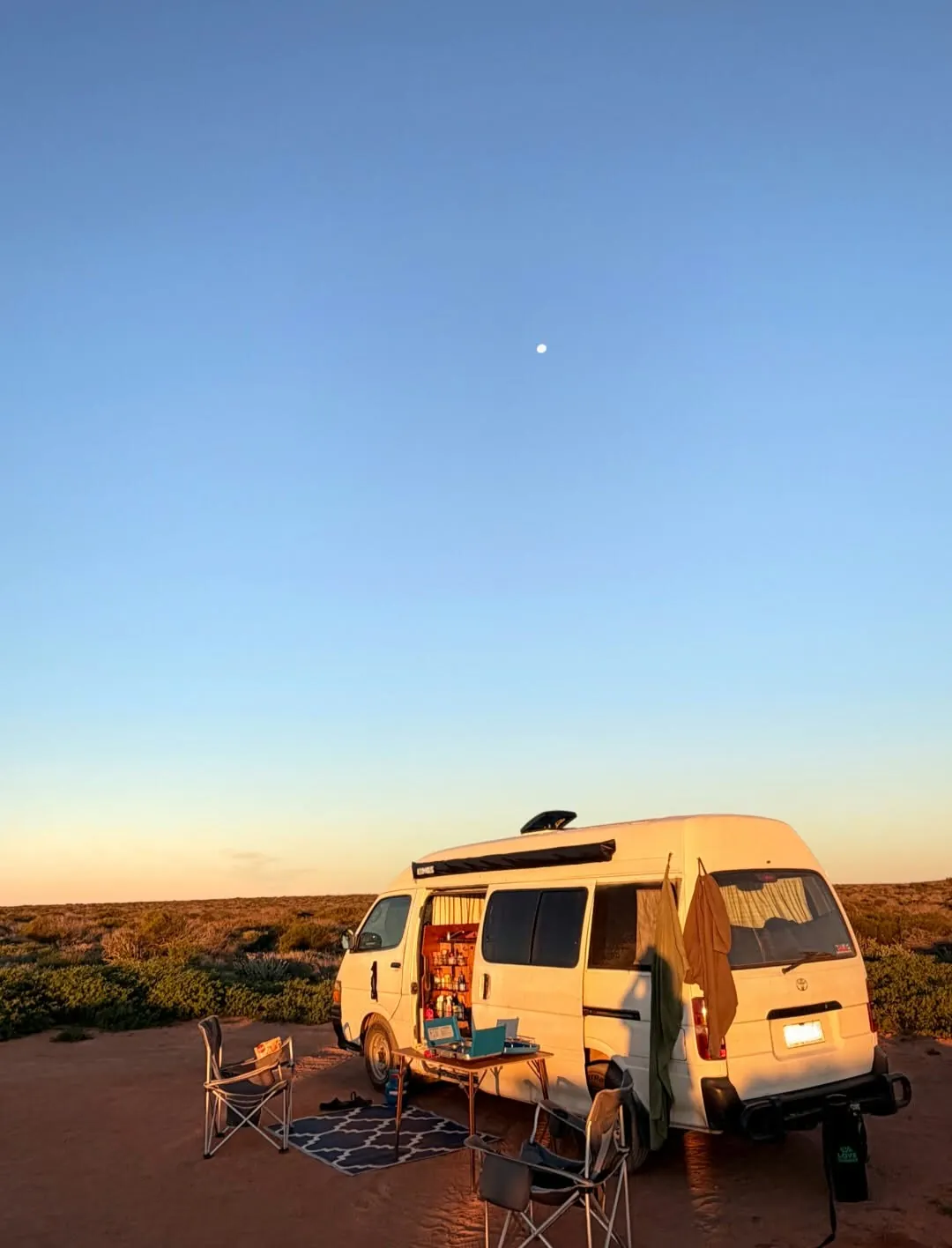Hank at sunset with the side door open and camp chairs out